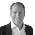 A black-and-white headshot of Jason Brooks