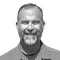 A black-and-white headshot of Mark Brown