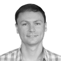 A black-and-white headshot of Scott Delaney