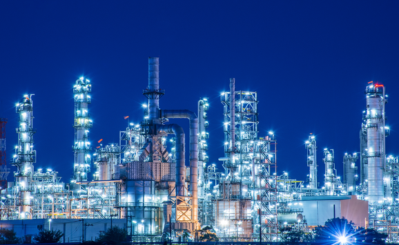 A fossil fuel refinery at night.