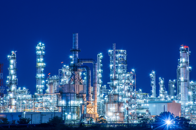 A fossil fuel refinery at night.