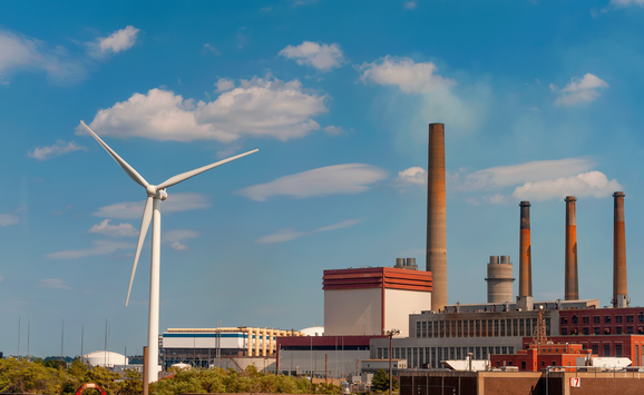 shutterstock_1897864297_wind turbine in front of factory.png
