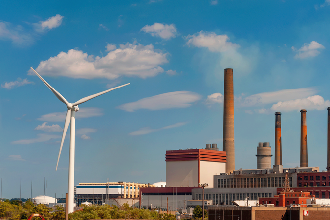 shutterstock_1897864297_wind turbine in front of factory.png