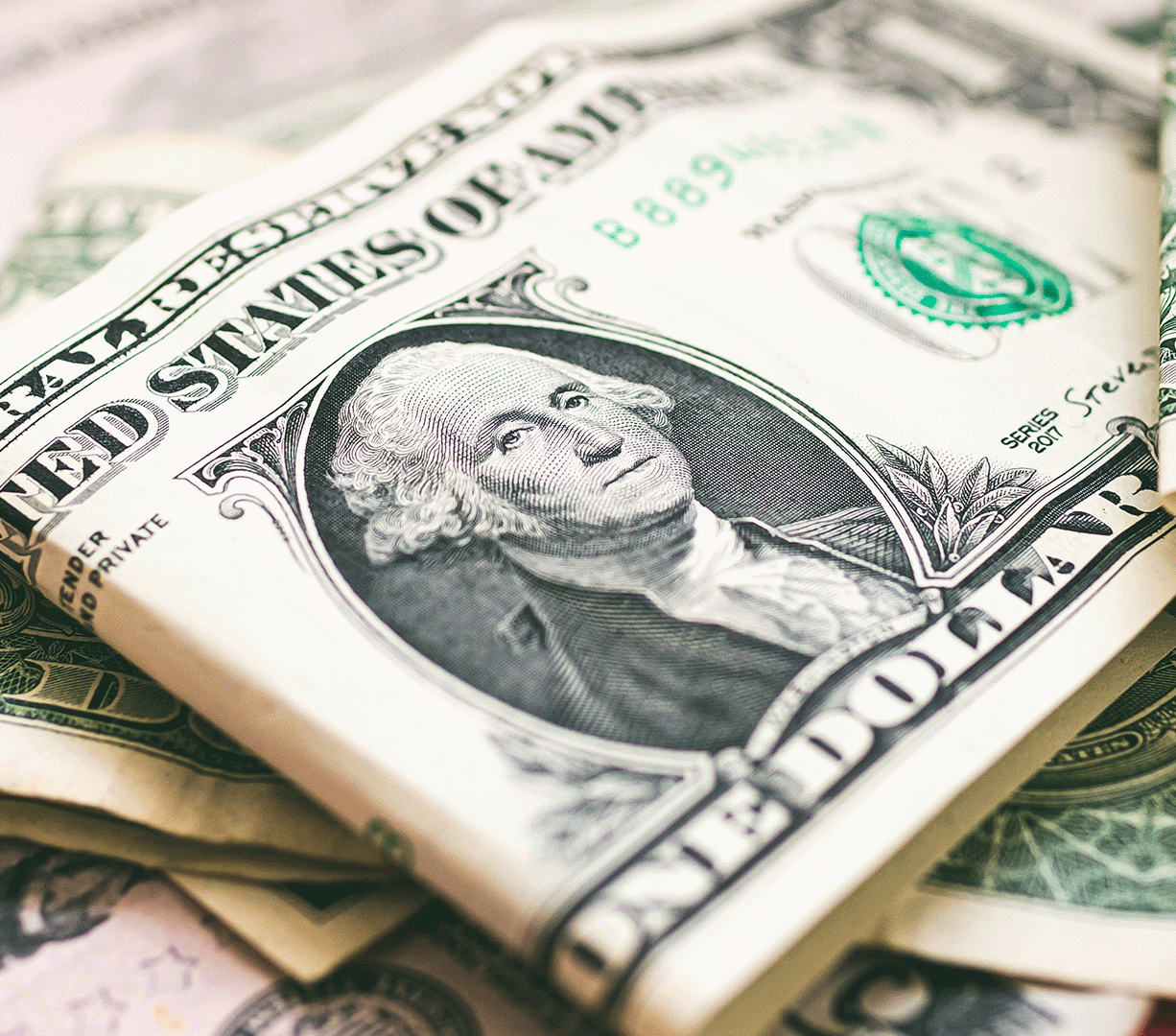 A close-up of American currency, including one- and five-dollar bills