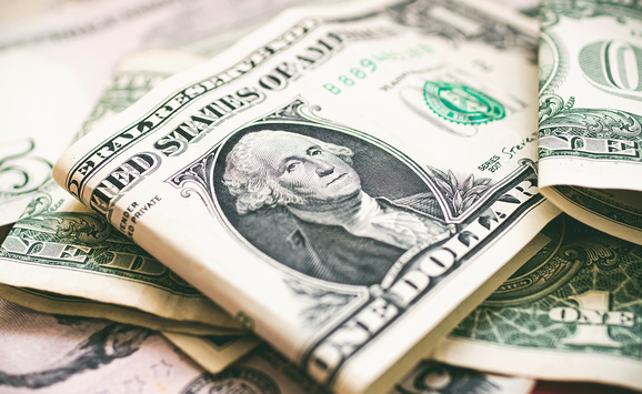 A close-up of American currency, including one- and five-dollar bills