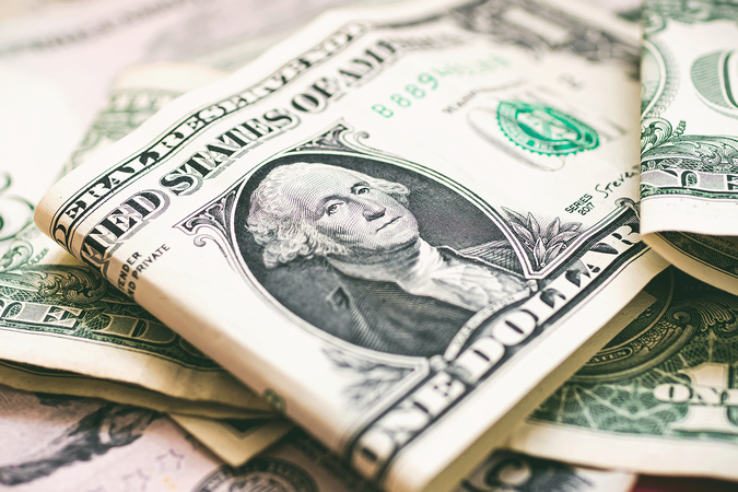 A close-up of American currency, including one- and five-dollar bills