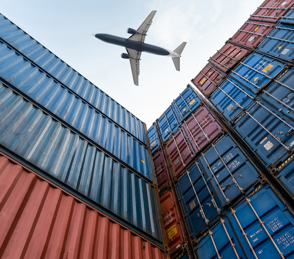 A view from below as a freight plane flies overhead stacked shipping containers