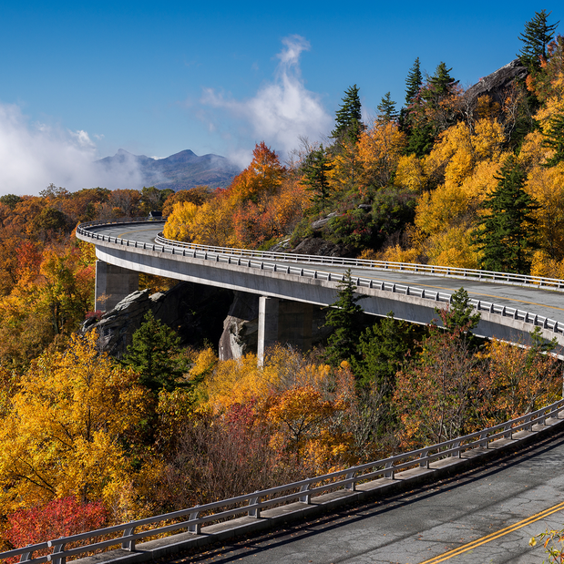The Blue Ridge Parkway curving around the slopes of Grandfather Mountain in North Carolina in the fall.