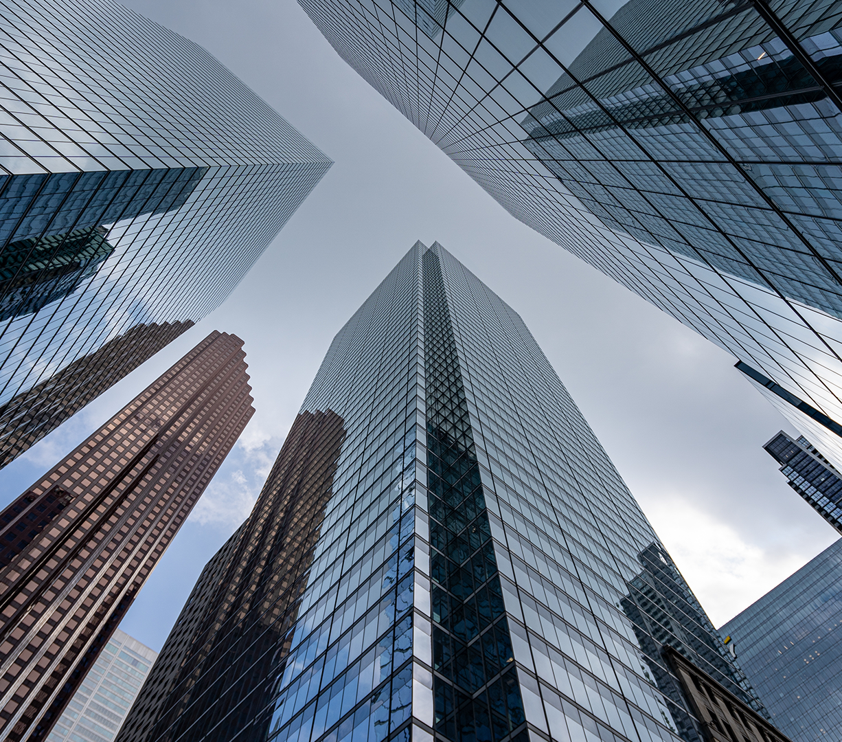A view upwards between city skyscrapers