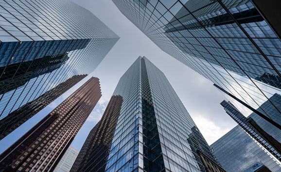 A view upwards between city skyscrapers