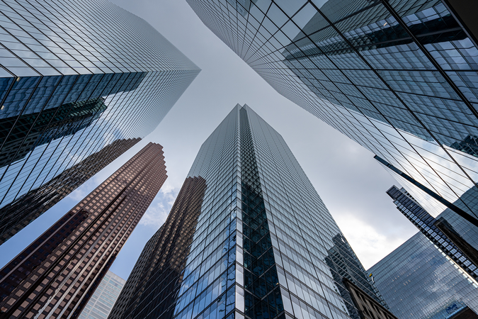 A view upwards between city skyscrapers