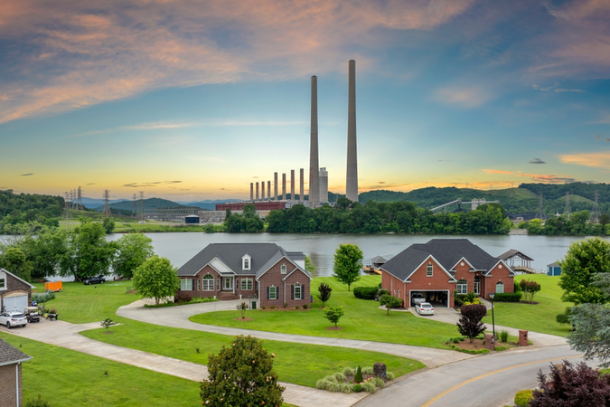 Neighborhood next to a thermal plant at sunset