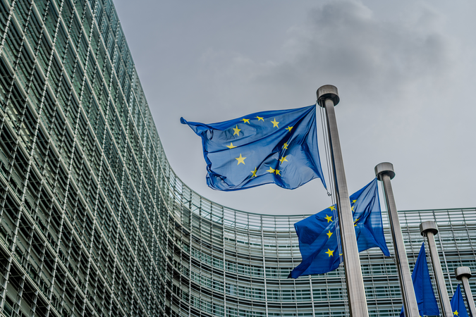 European Union flags flying in front of the Berlaymont building, which is the headquarters of the European commission located in Brussels.