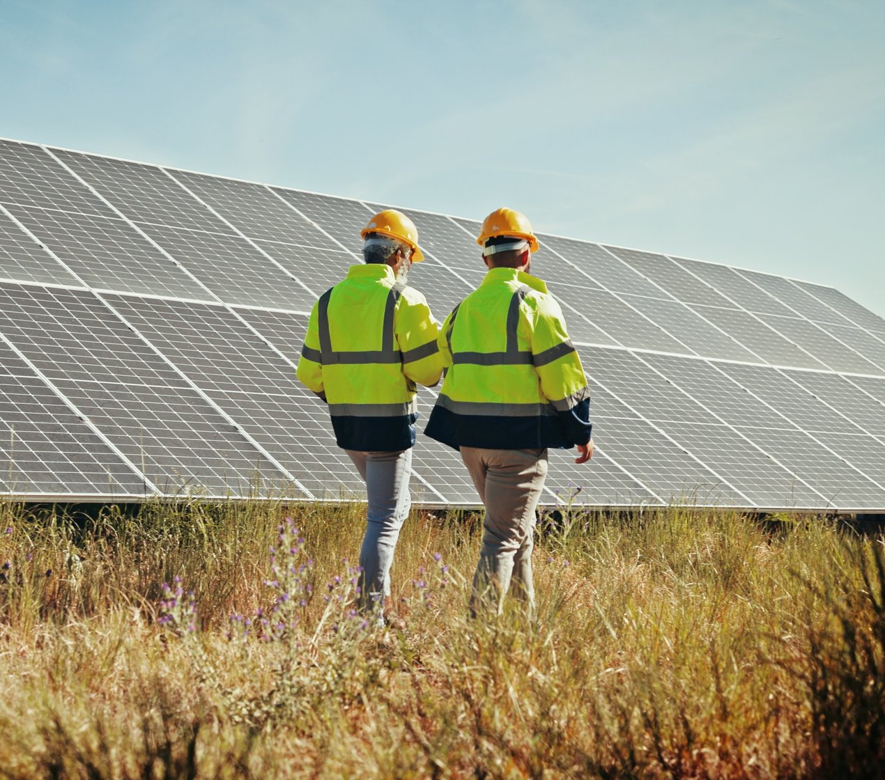 engineers inspecting solar panels / shutterstock_2557820731