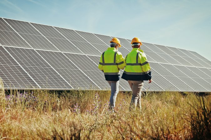 engineers inspecting solar panels / shutterstock_2557820731