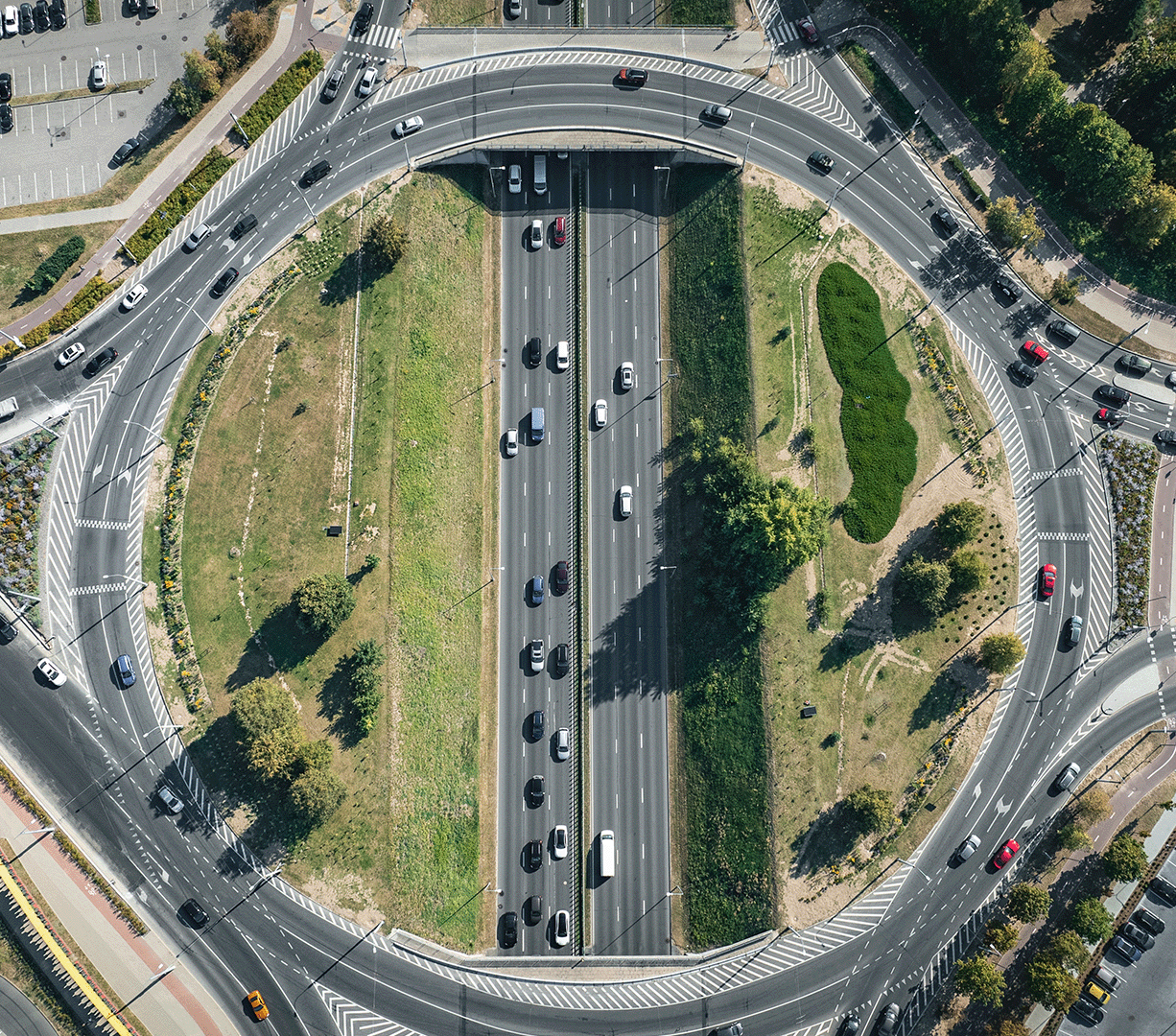 An aerial view of vehicles navigating a busy traffic circle
