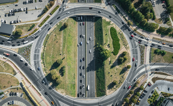 An aerial view of vehicles navigating a busy traffic circle