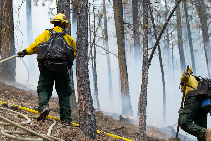 Firefighters containing a wildfire on a mountainside in California