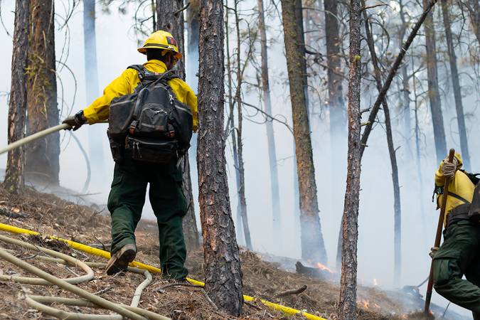Firefighters containing a wildfire on a mountainside in California