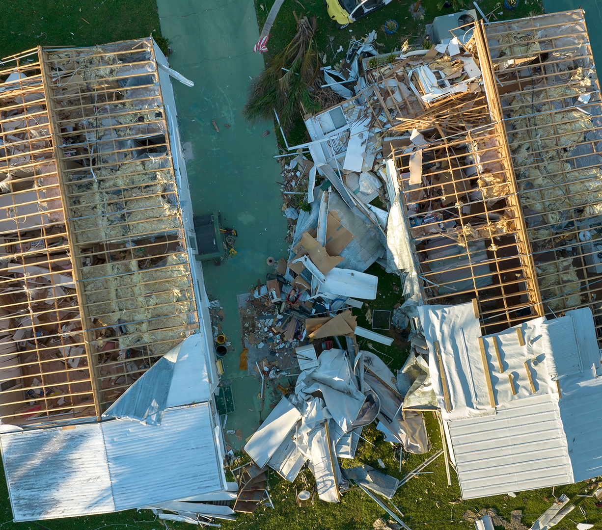An aerial view of houses damaged by a hurricane