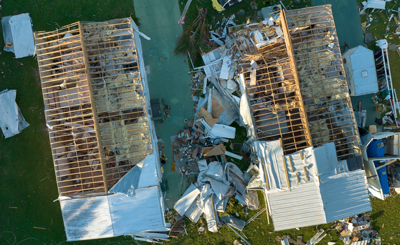 An aerial view of houses damaged by a hurricane