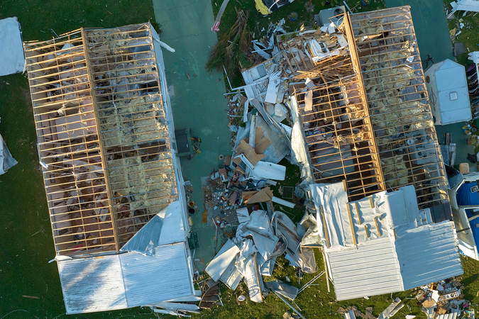 An aerial view of houses damaged by a hurricane